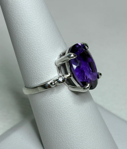 Sterling silver ring with a large oval amethyst gemstone.