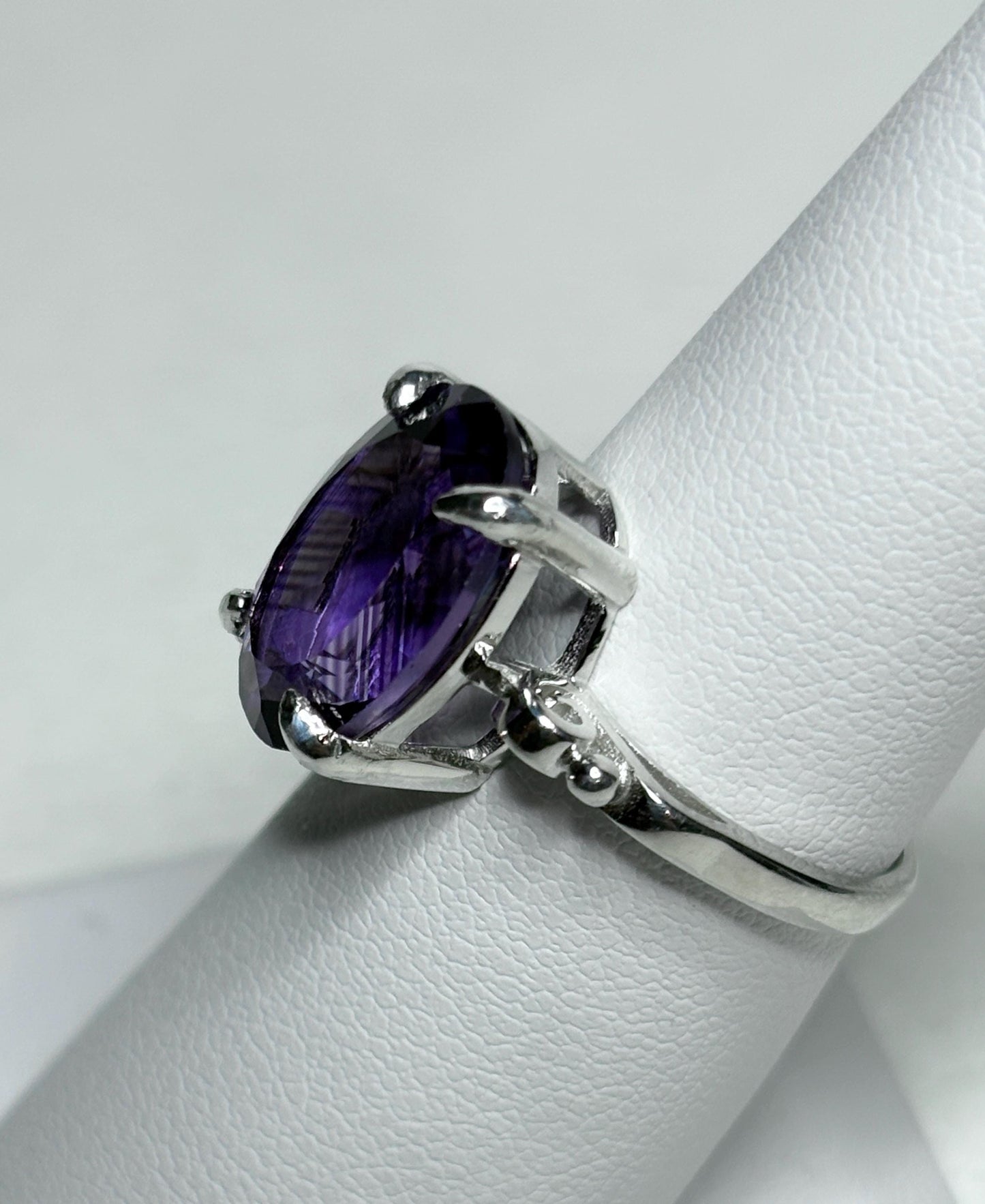 Sterling silver ring with a large oval amethyst gemstone.