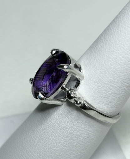 Sterling silver ring with a large oval amethyst gemstone.
