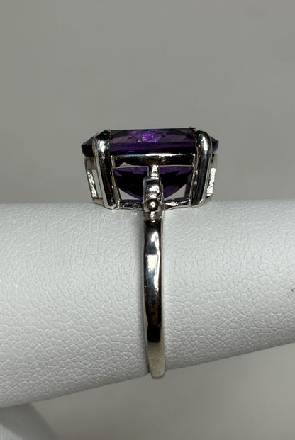 Sterling silver ring with a large oval amethyst gemstone.