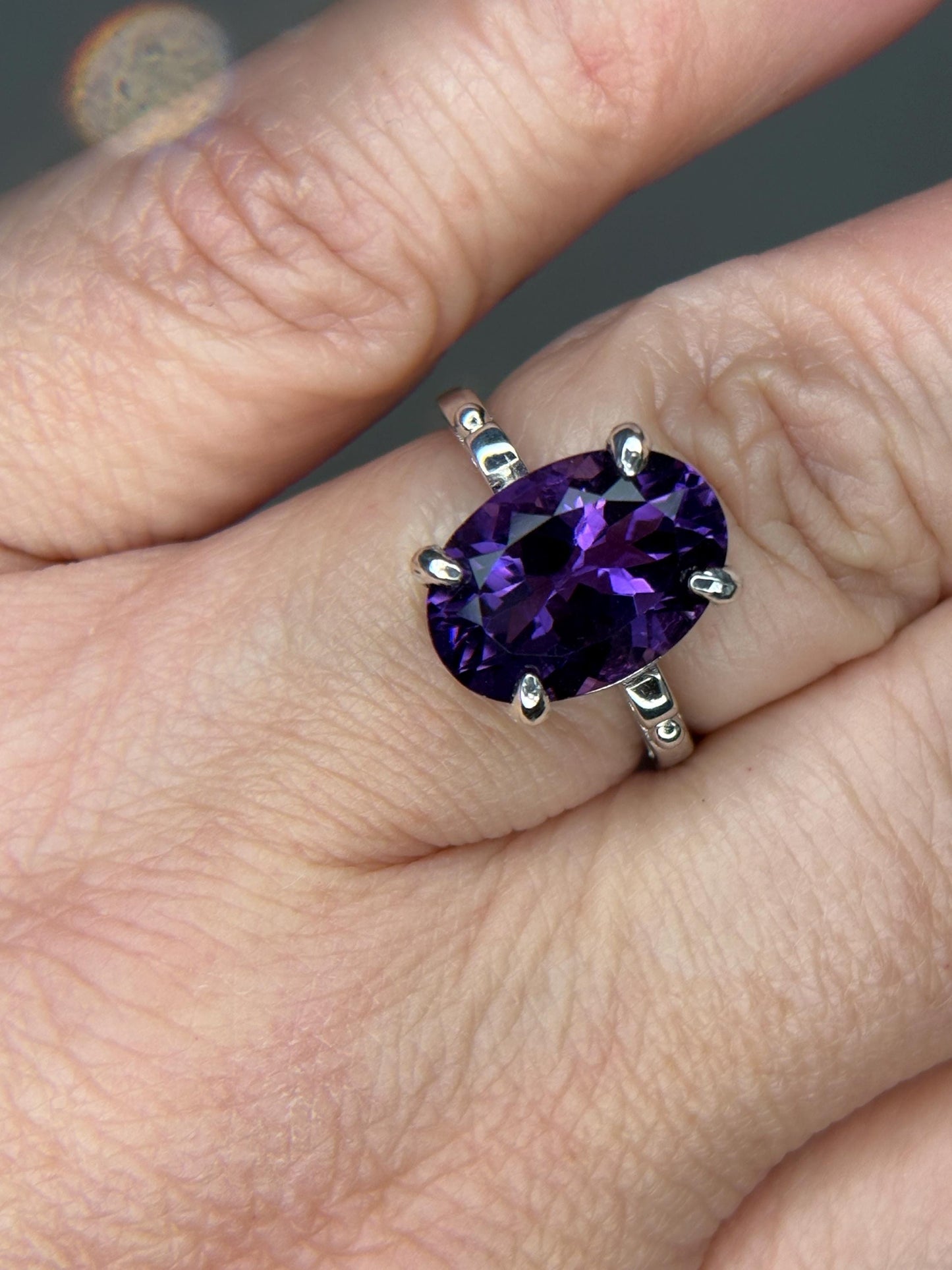 Sterling silver ring with a large oval amethyst gemstone.