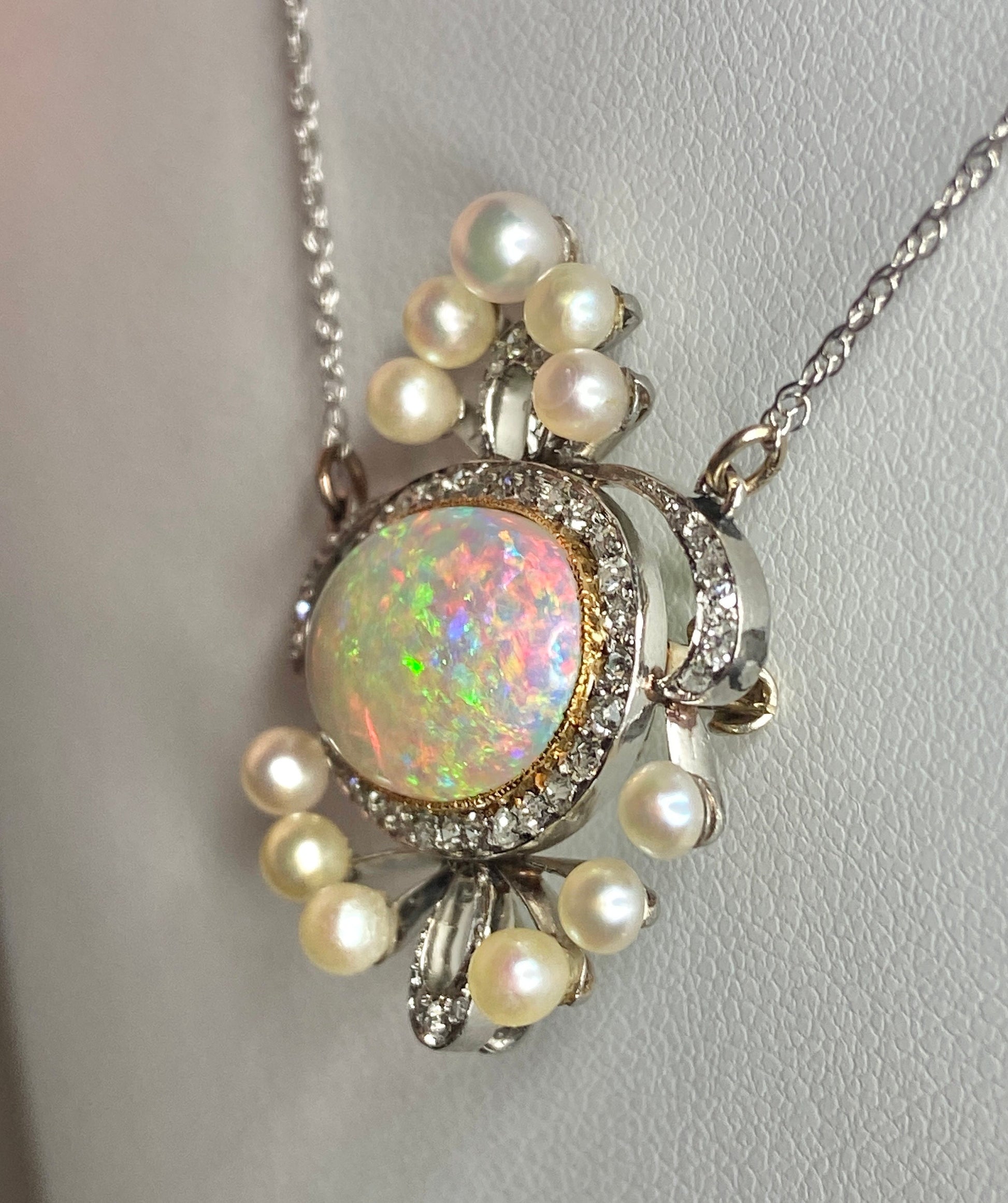 Platinum, 18k, and 14k gold necklace with opal, pearls, and diamonds.