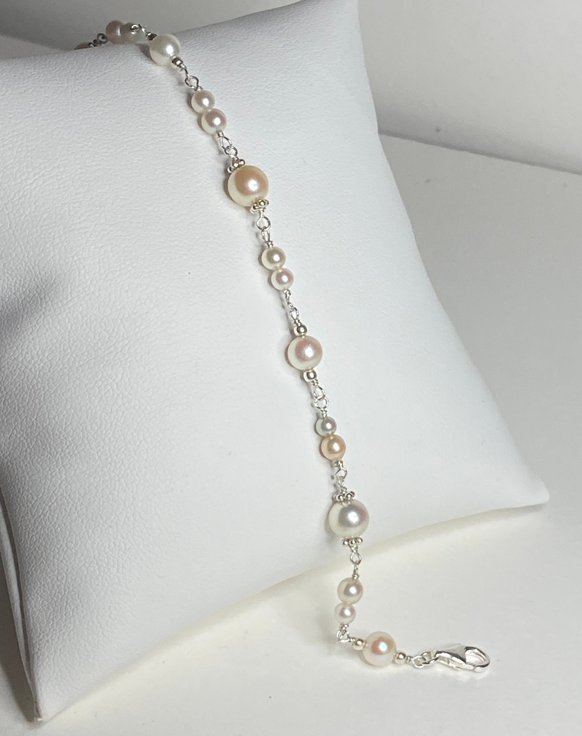 Sterling silver bracelet with multi-colored and sized Akoya pearls.