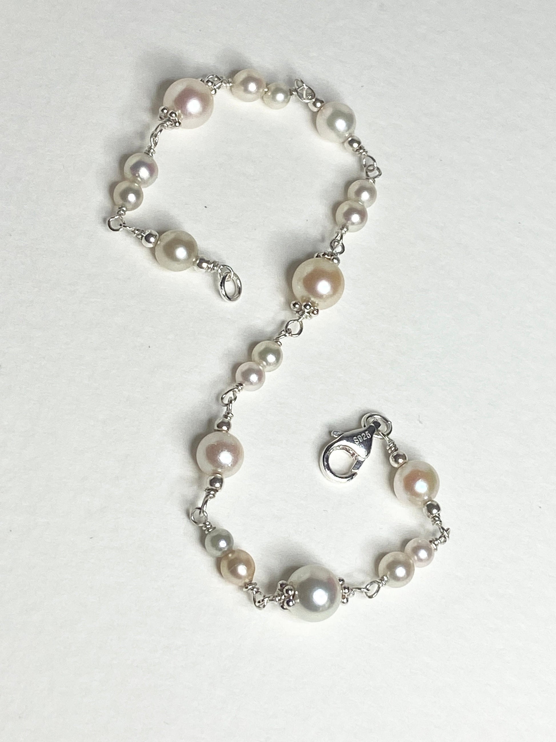 Sterling silver bracelet with multi-colored Akoya pearls of varying sizes.