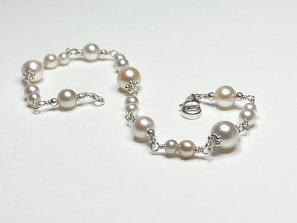 Sterling silver bracelet with multi-colored Akoya pearls of varying sizes.