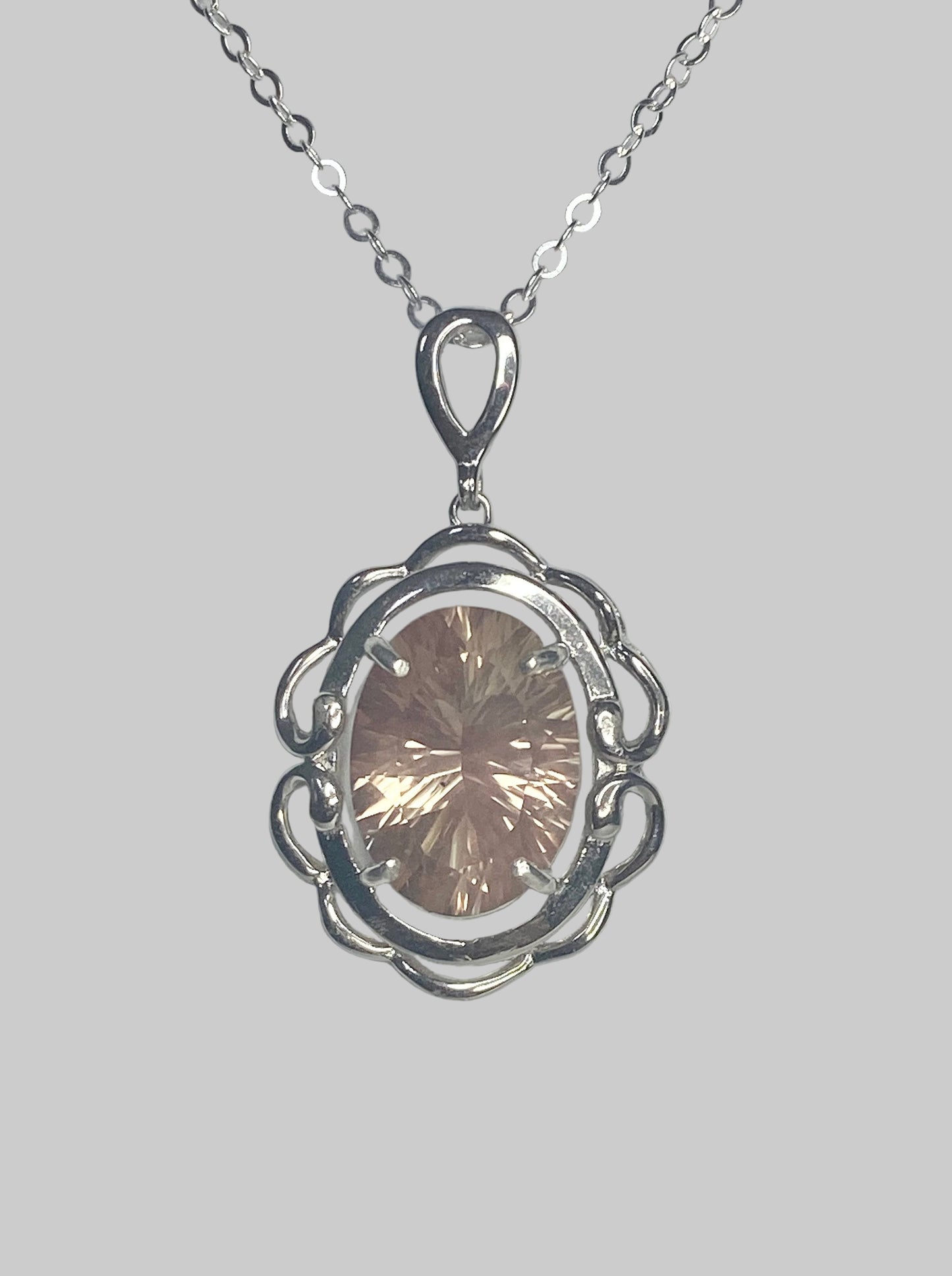 Sterling silver pendant necklace with a large oval fancy cut Oregon Sunstone.