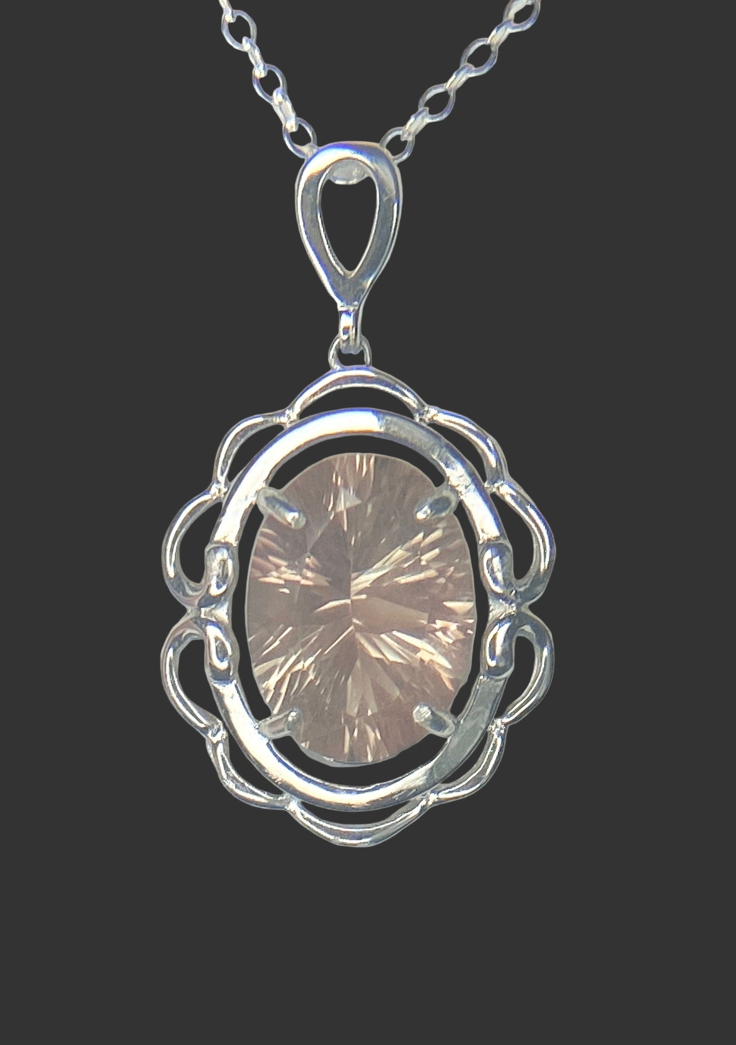 Sterling silver pendant necklace featuring a large oval fancy cut Oregon Sunstone.