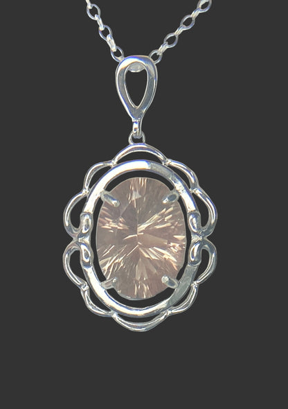 Sterling silver pendant necklace featuring a large oval fancy cut Oregon Sunstone.