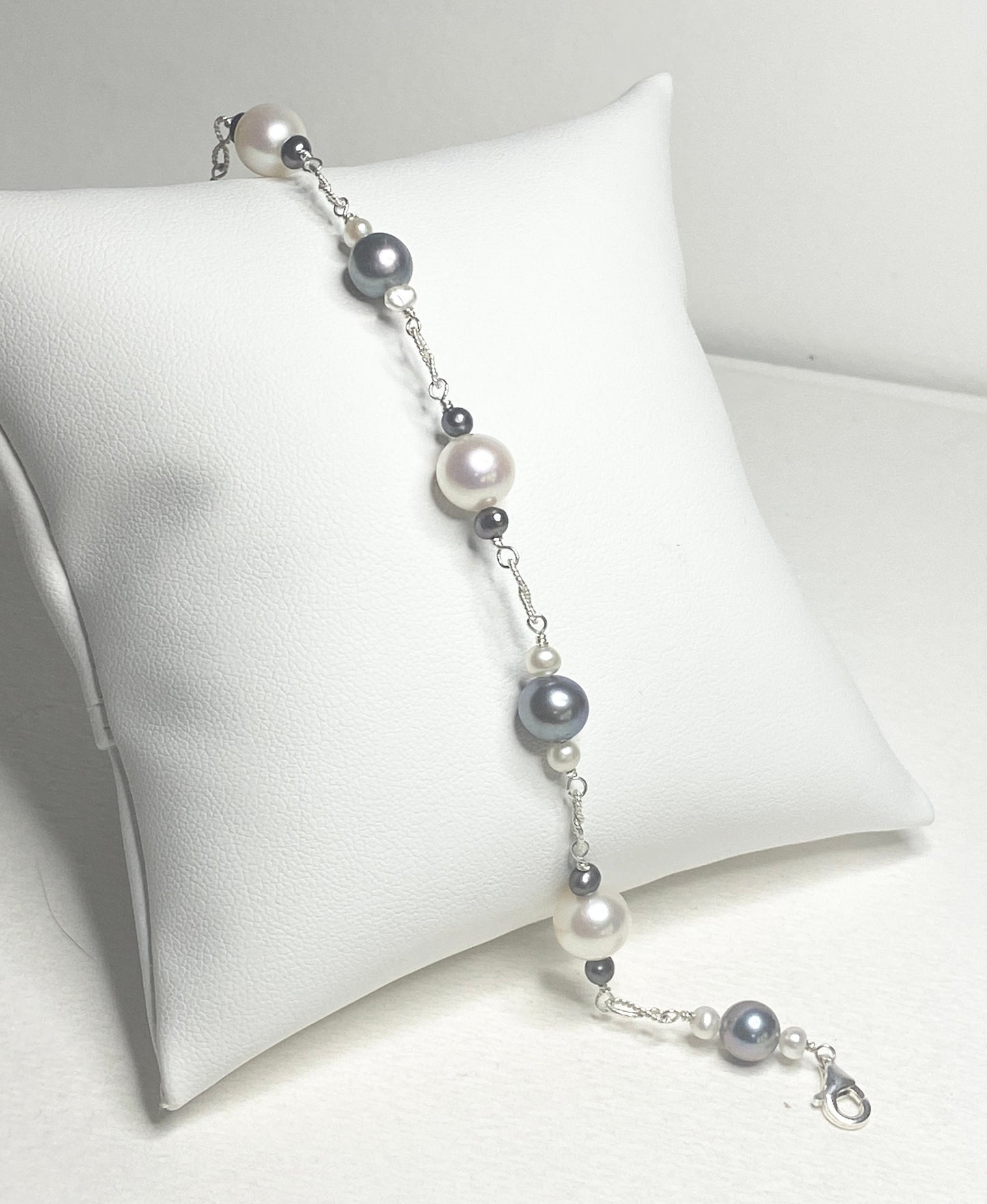 Sterling silver bracelet with Akoya, Tahitian, and freshwater pearls in black and white.