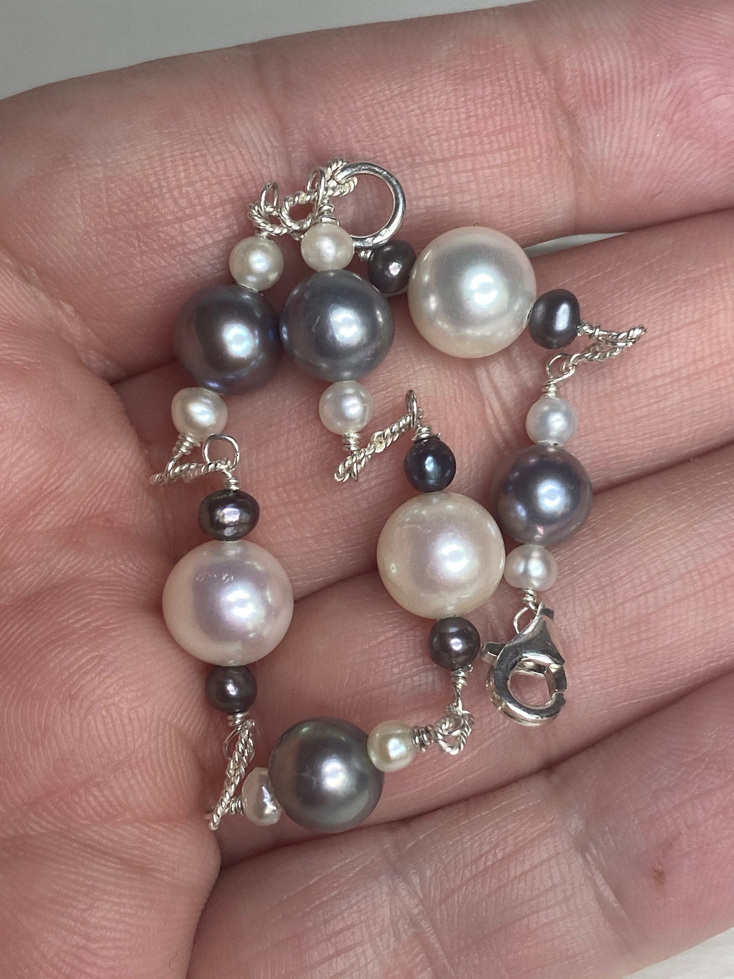 Sterling silver bracelet with Akoya, Tahitian, and freshwater pearls in black and white.