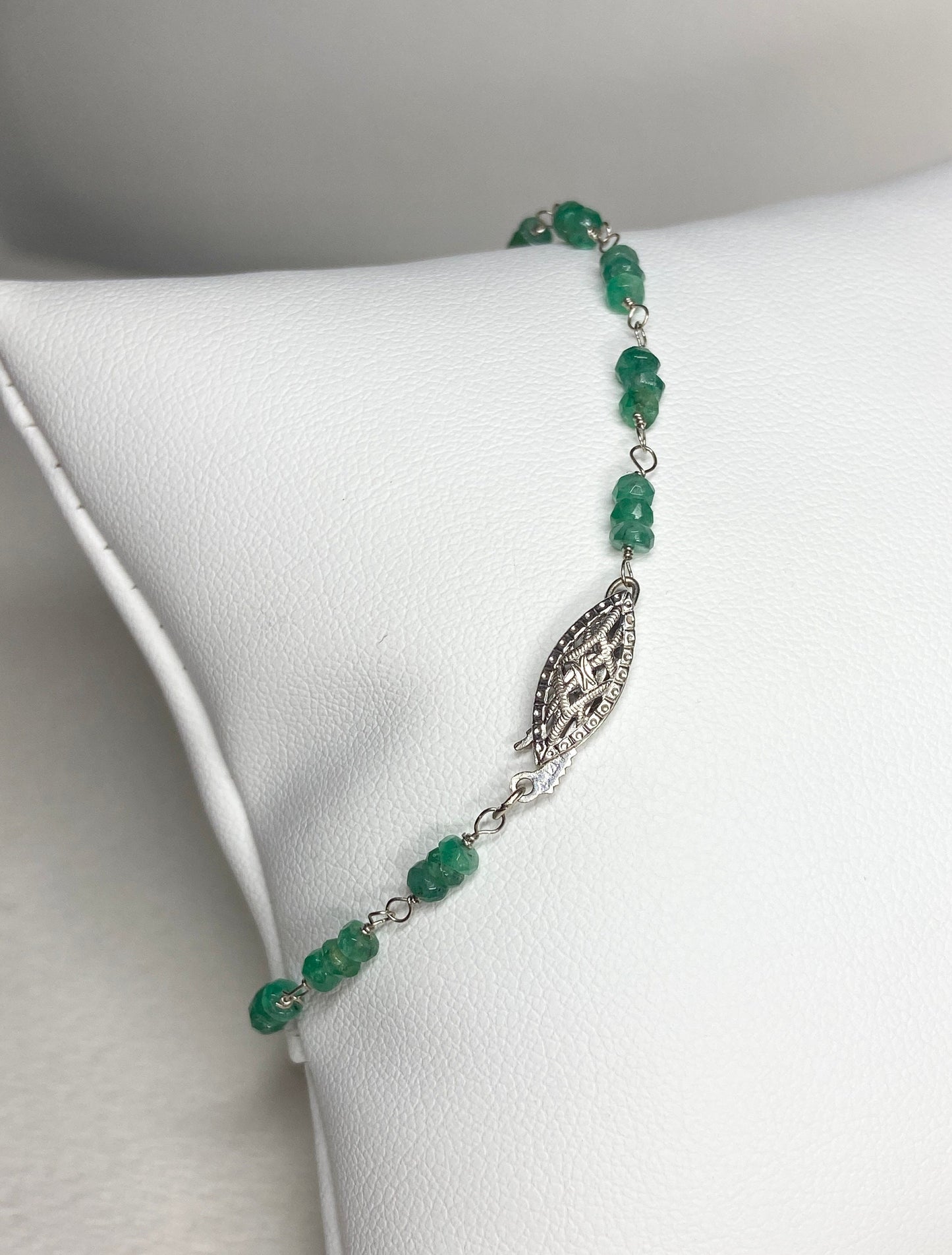 A 7.5 inch bracelet with faceted emerald beads and a white gold clasp.