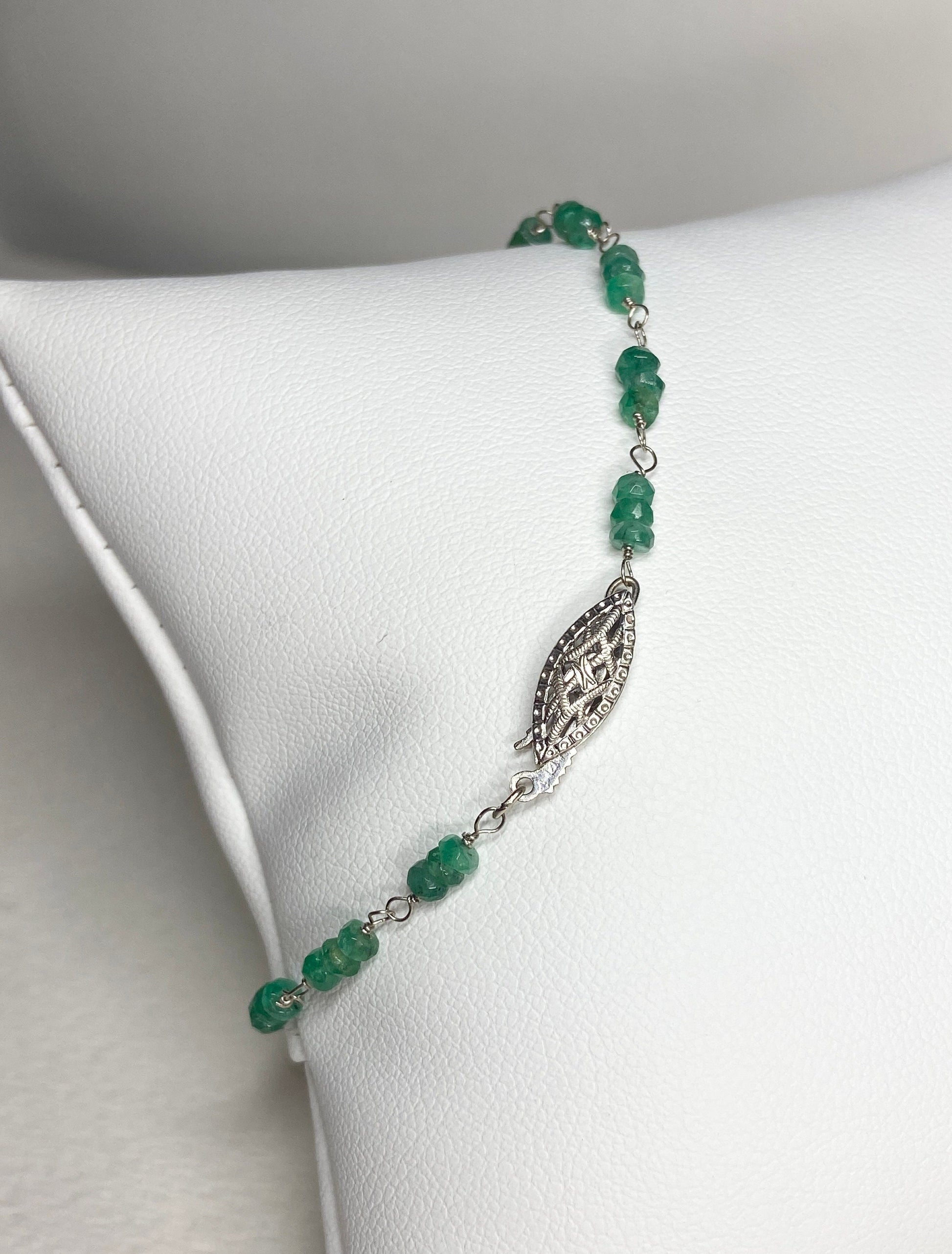 A 7.5 inch bracelet with faceted emerald beads and a white gold clasp.