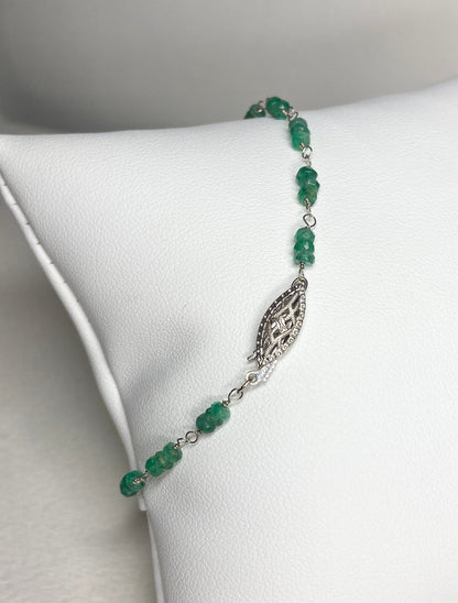 A 7.5 inch bracelet with faceted emerald beads and a white gold clasp.