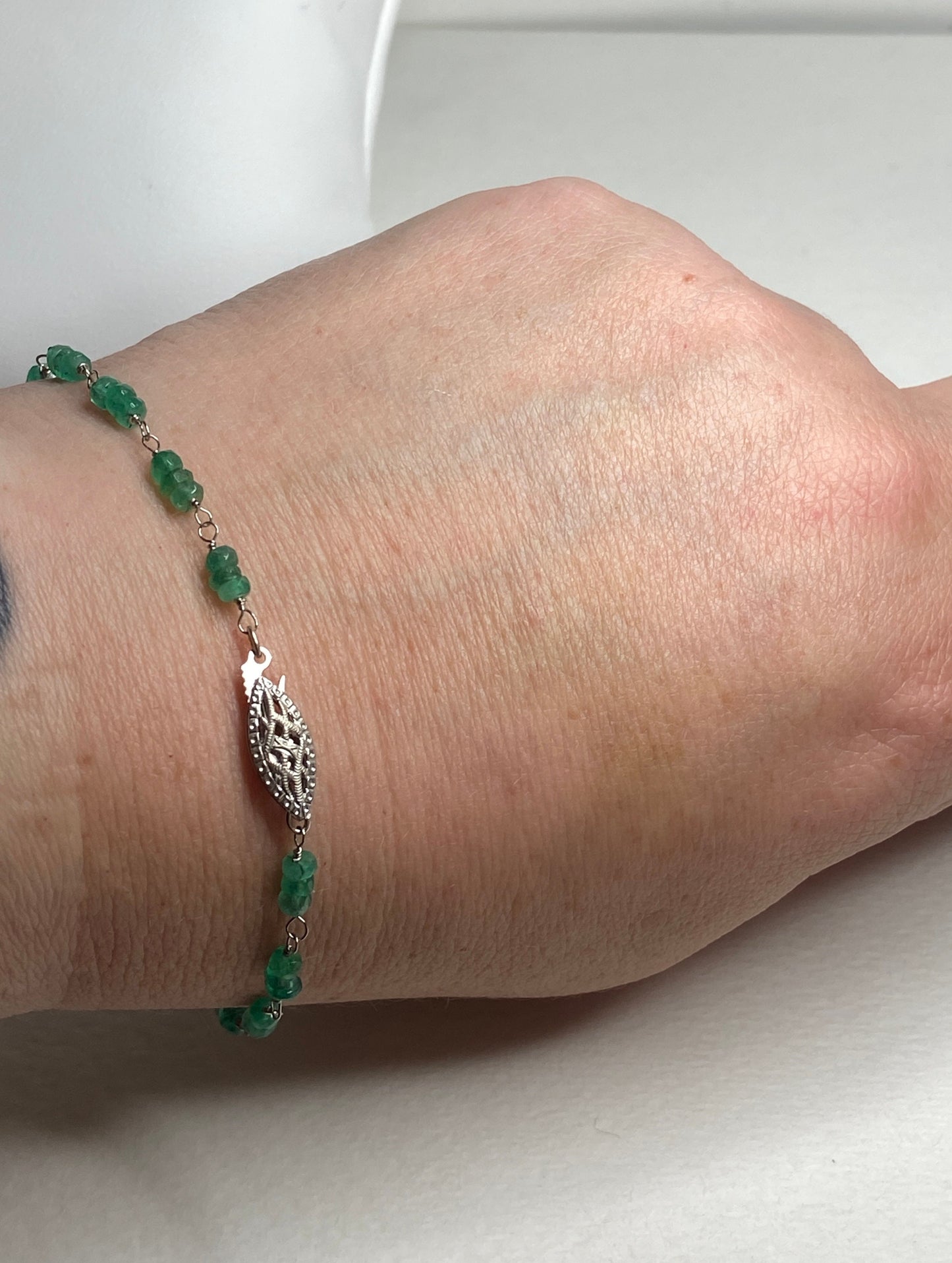 A 7.5 inch bracelet with natural emerald beads and a white gold clasp.