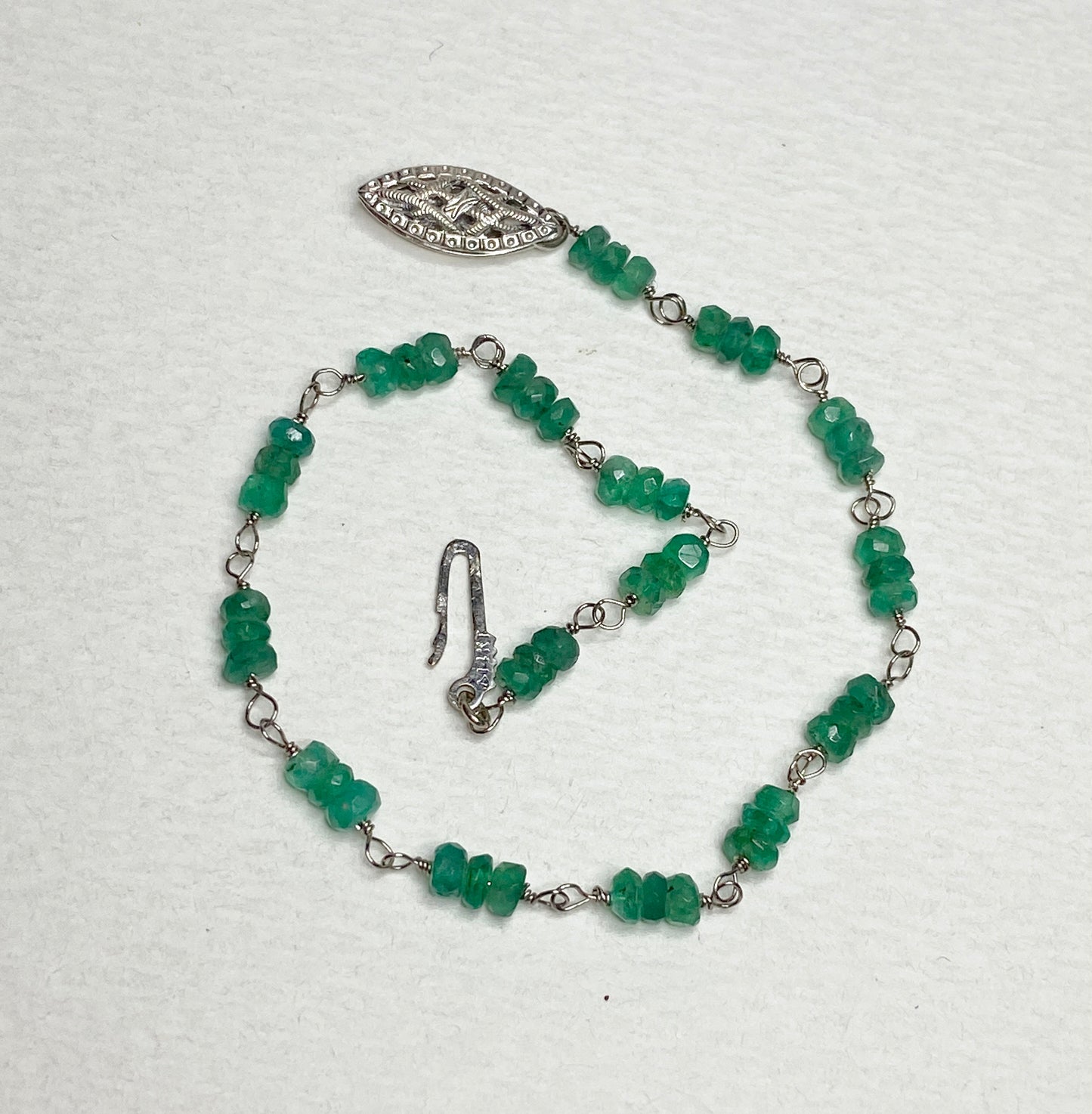 A 7.5 inch bracelet with natural emerald beads and a white gold clasp.