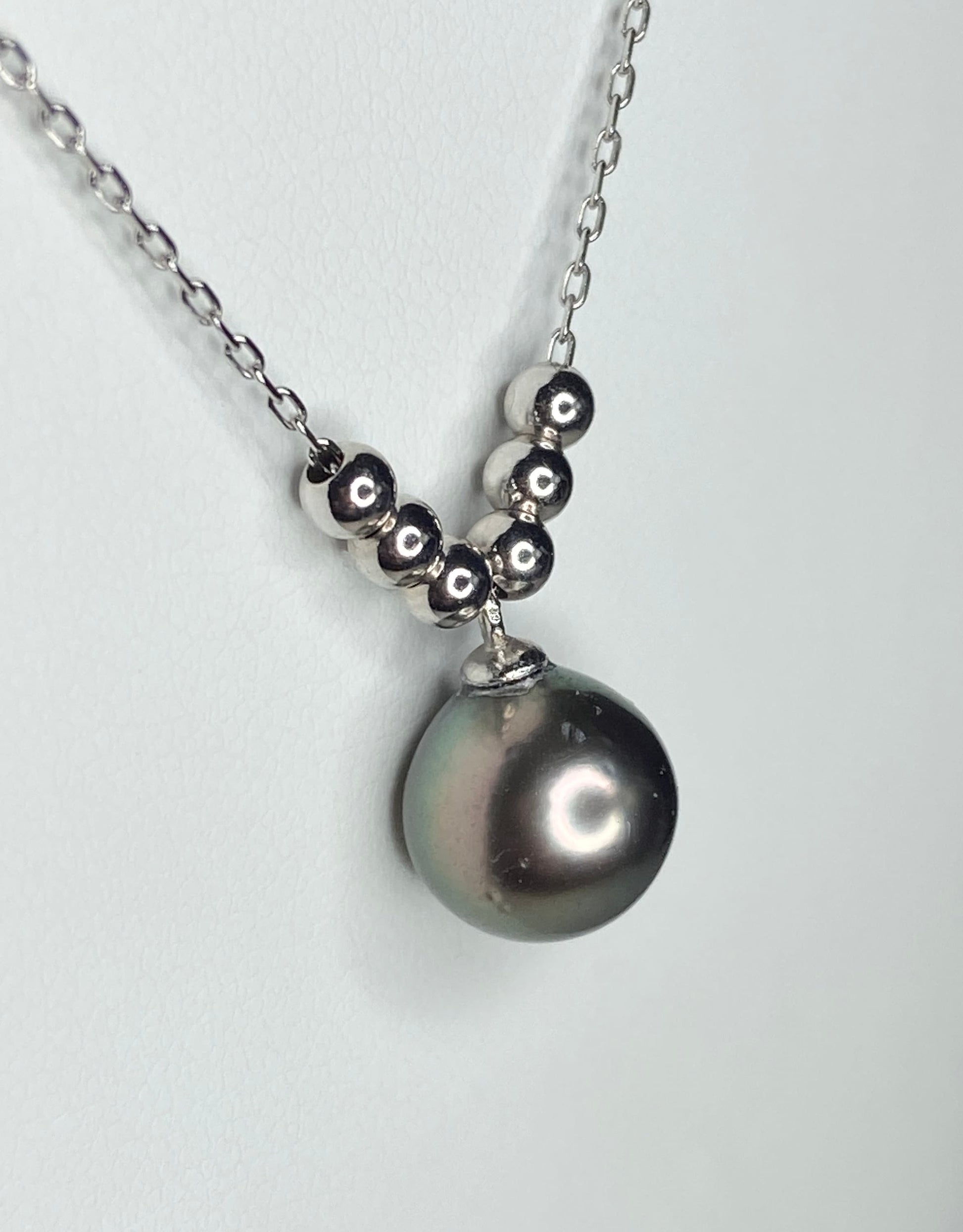 Tahitian cultured pearl pendant necklace with beads on an adjustable sterling silver chain.