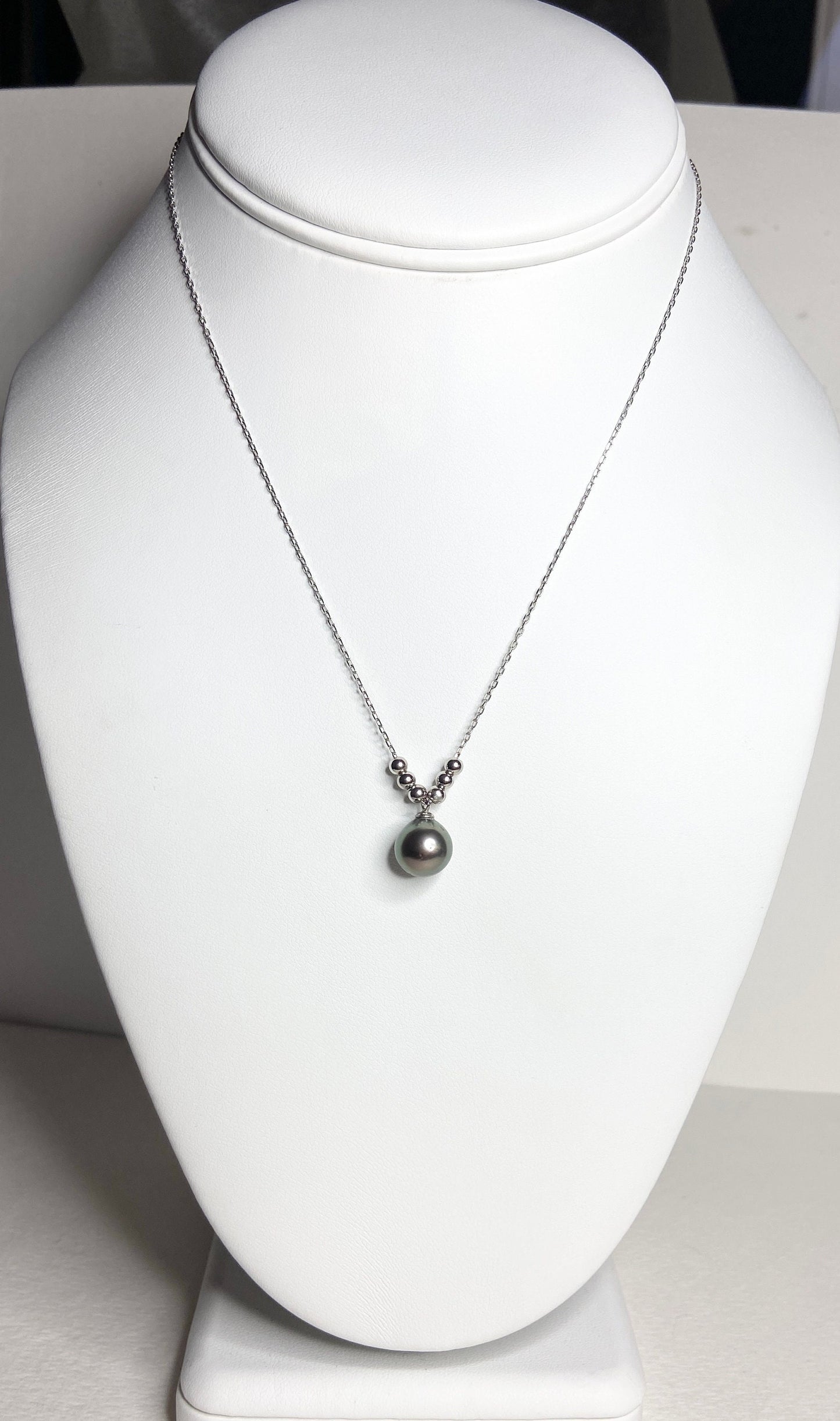 Sterling silver necklace with a Tahitian pearl pendant and silver beads.