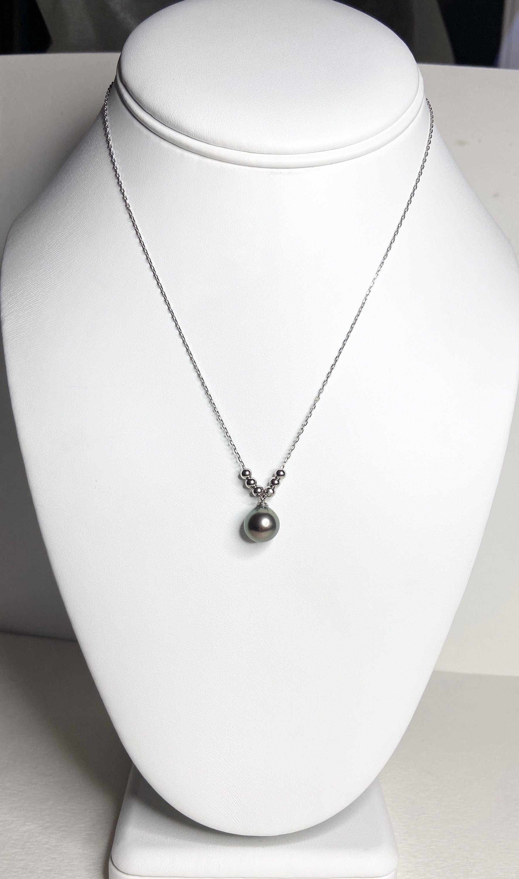Sterling silver necklace with a Tahitian pearl pendant and silver beads.