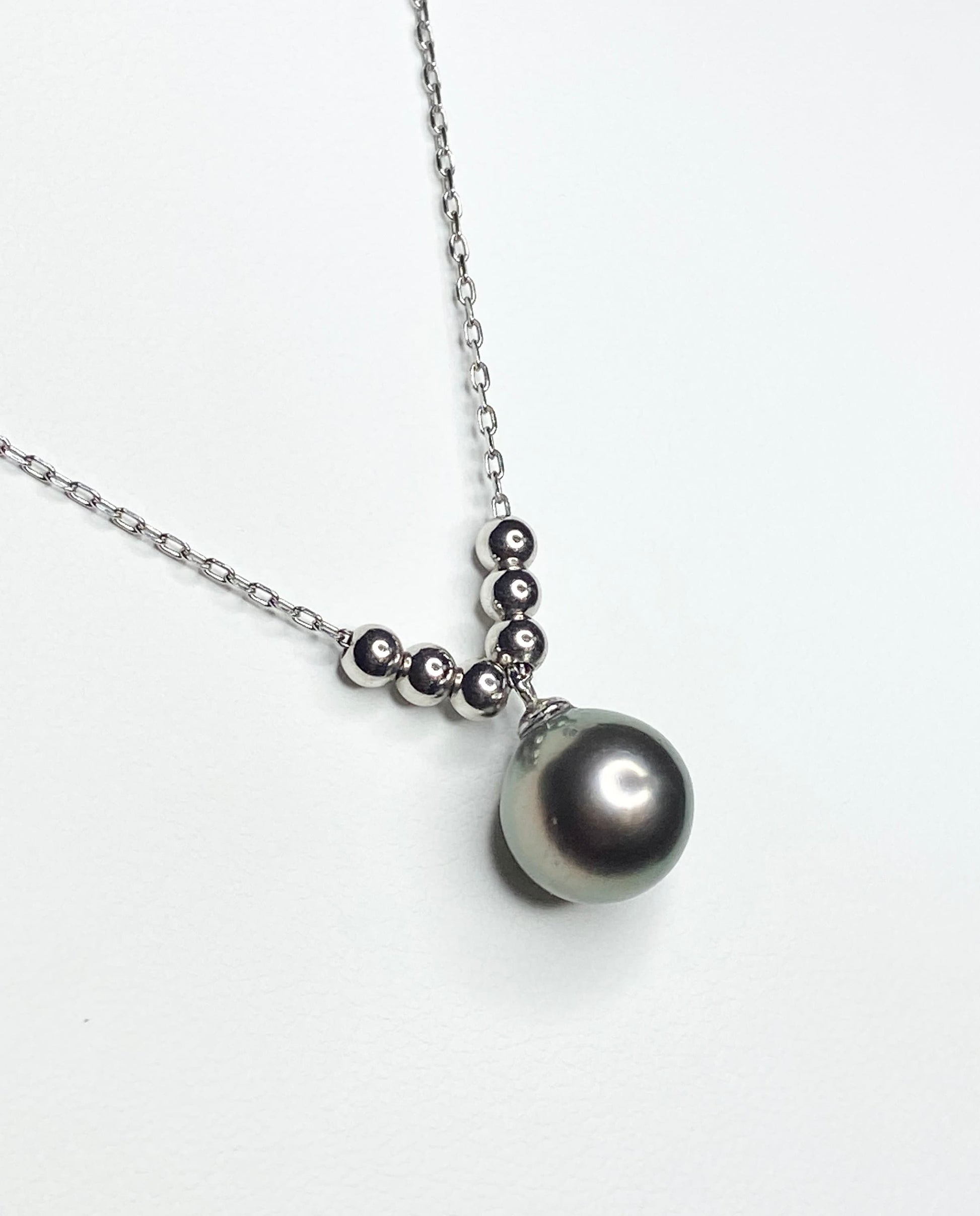 Sterling silver necklace with a Tahitian pearl and floating beads.