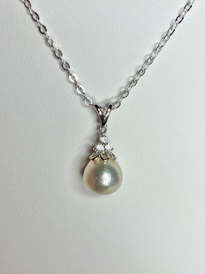 Sterling silver necklace with an out-of-round Akoya pearl pendant and crystal accents.