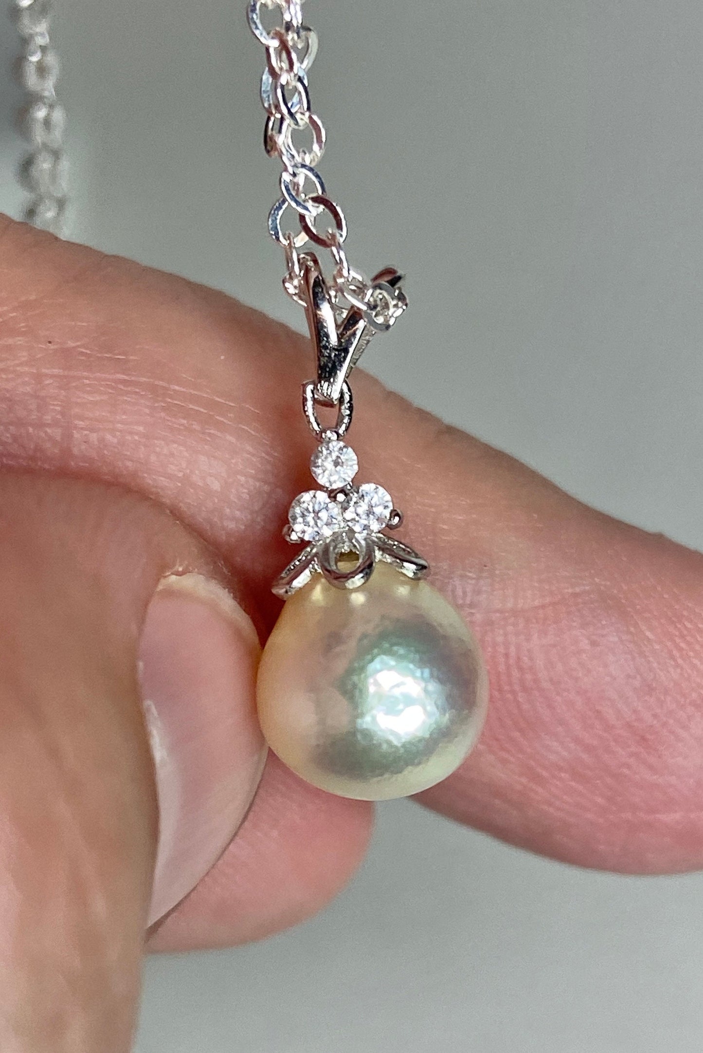 Sterling silver pendant necklace with an out-of-round Akoya pearl and crystal accents.
