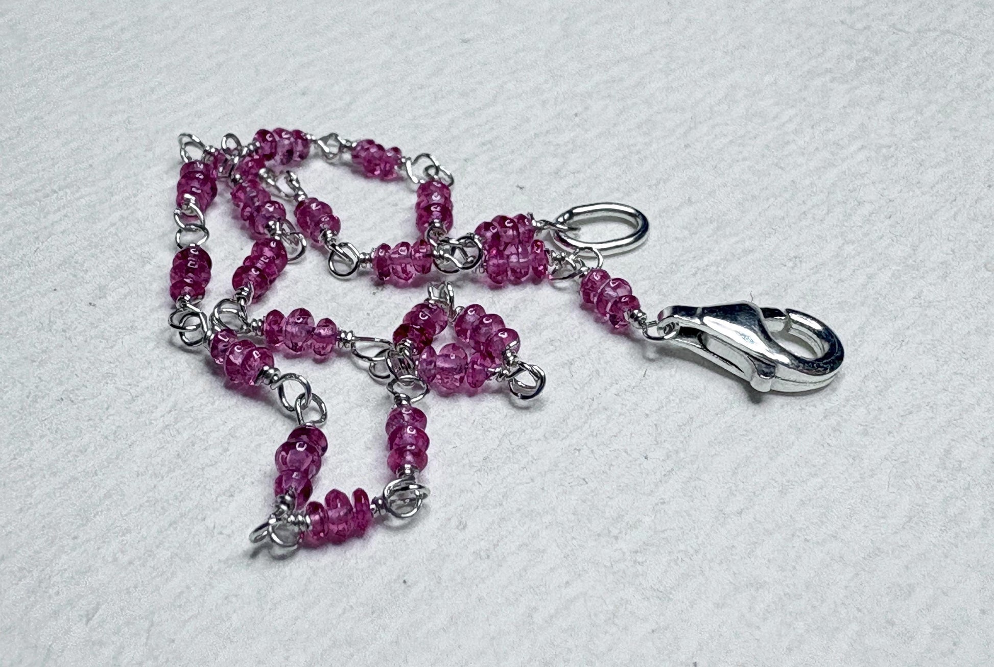 Sterling silver bracelet with hot pink spinel beads and a lobster clasp.