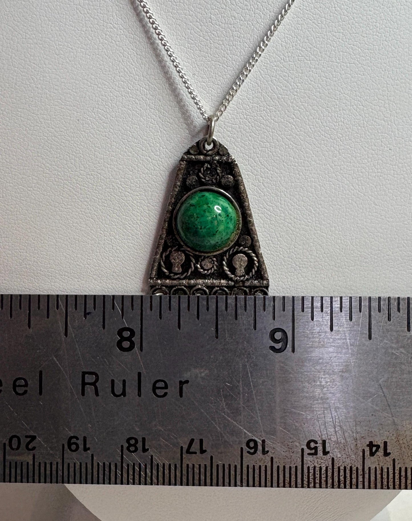 Israeli sterling silver fringe pendant with a green stone, measured against a ruler.