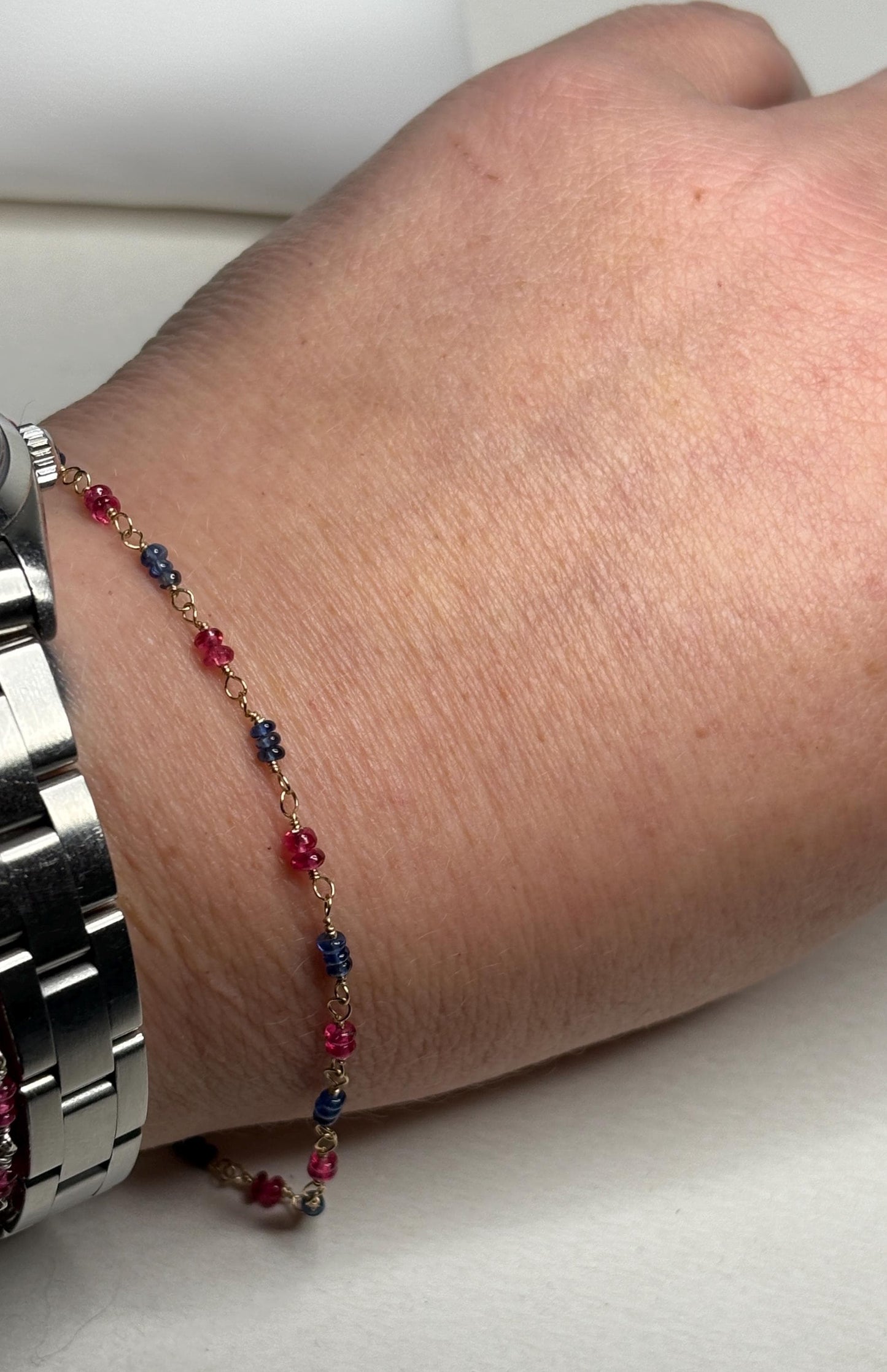 Dainty 14k gold bracelet with smooth Burmese sapphire and red spinel beads.