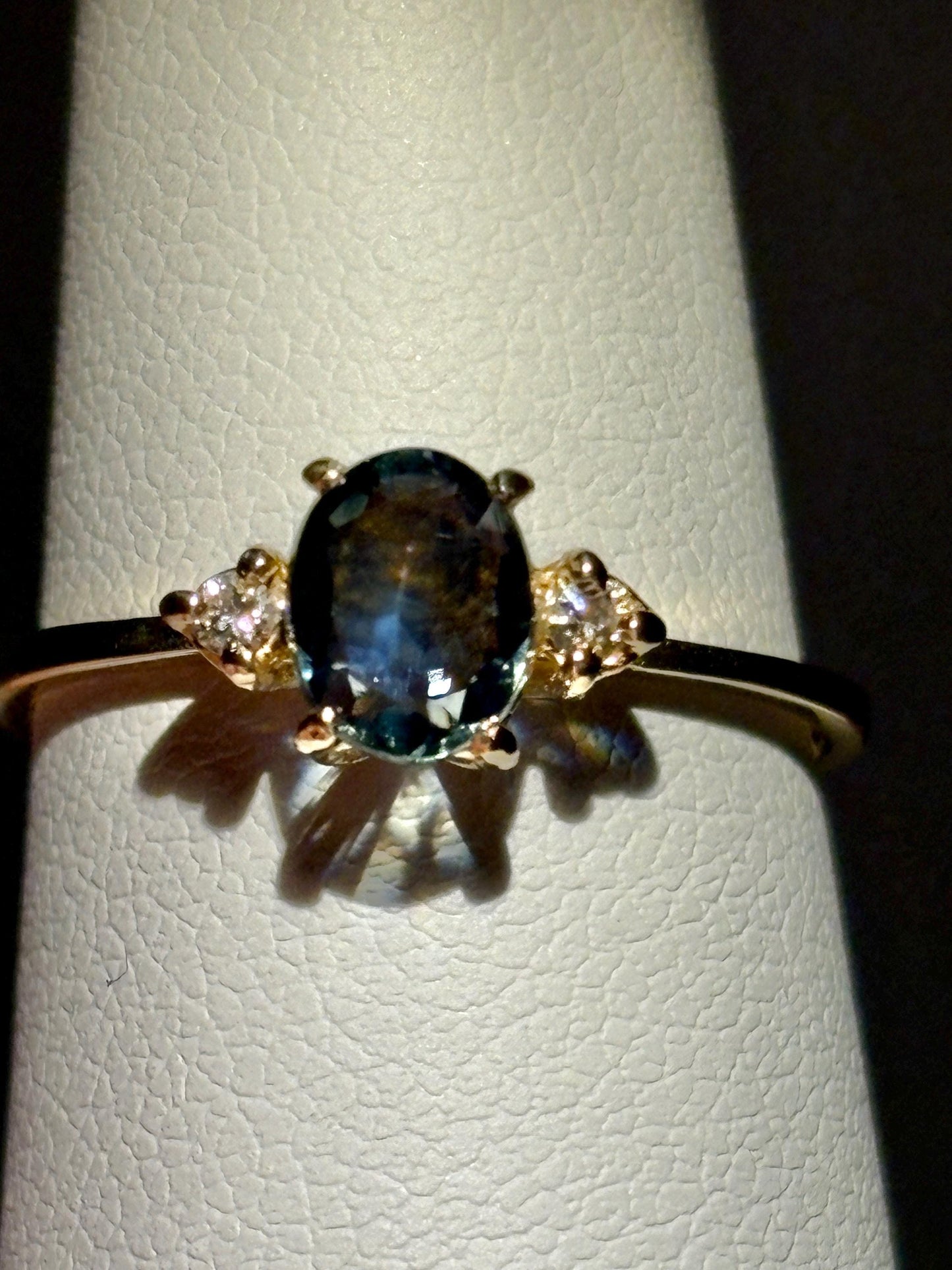 Oval Montana sapphire and diamond ring in 14k yellow gold.