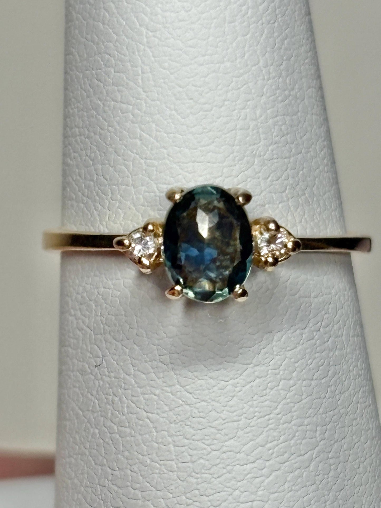 Oval Montana sapphire and diamond ring in 14k yellow gold.