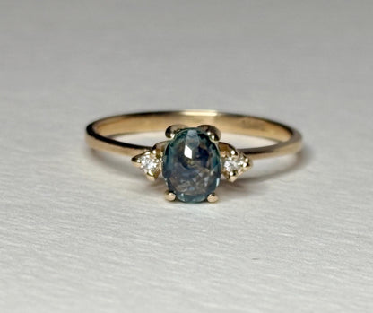 Oval Montana sapphire and diamond ring in 14k yellow gold.