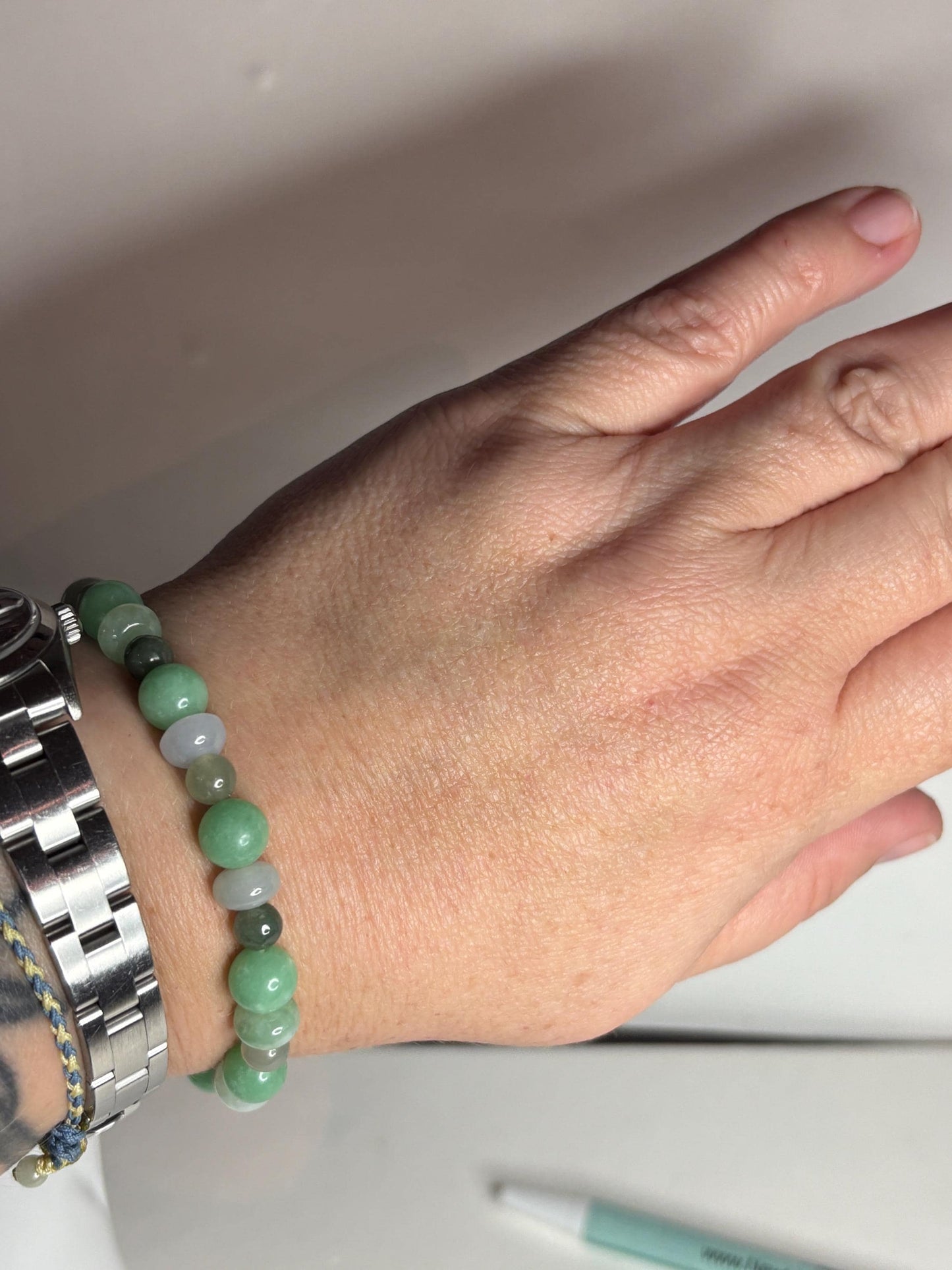 Burmese jadeite jade stretch bracelet with mixed green and white beads.