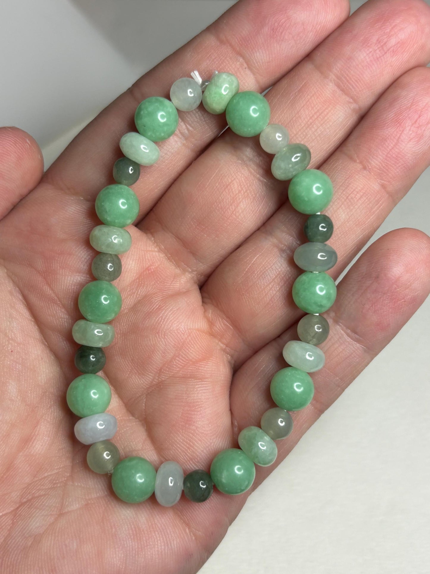 Burmese jadeite jade stretch bracelet with mixed green beads.