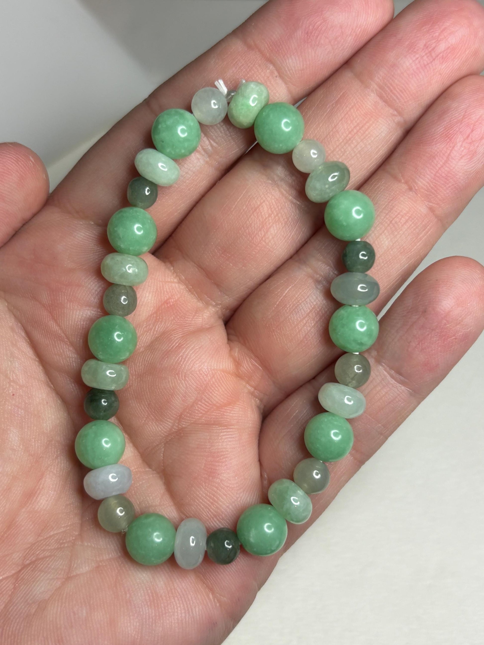 Burmese jadeite jade stretch bracelet with mixed green beads.