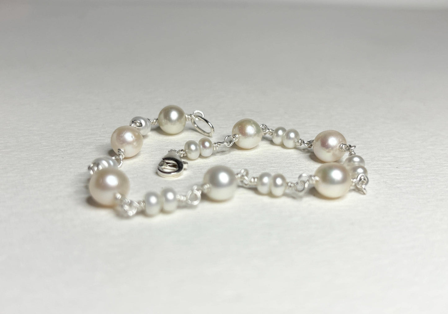 Sterling silver bracelet with cultured freshwater pearls.