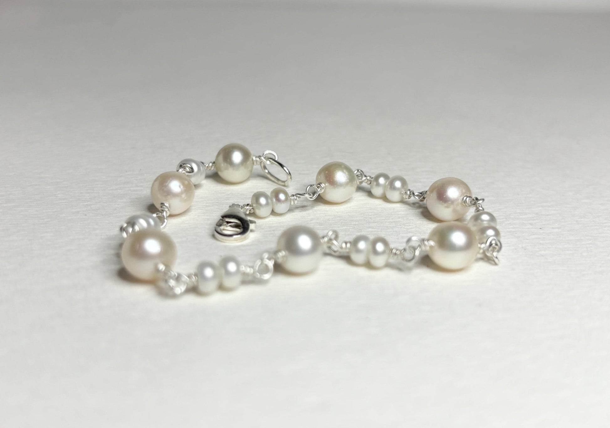 Sterling silver bracelet with cultured freshwater pearls.