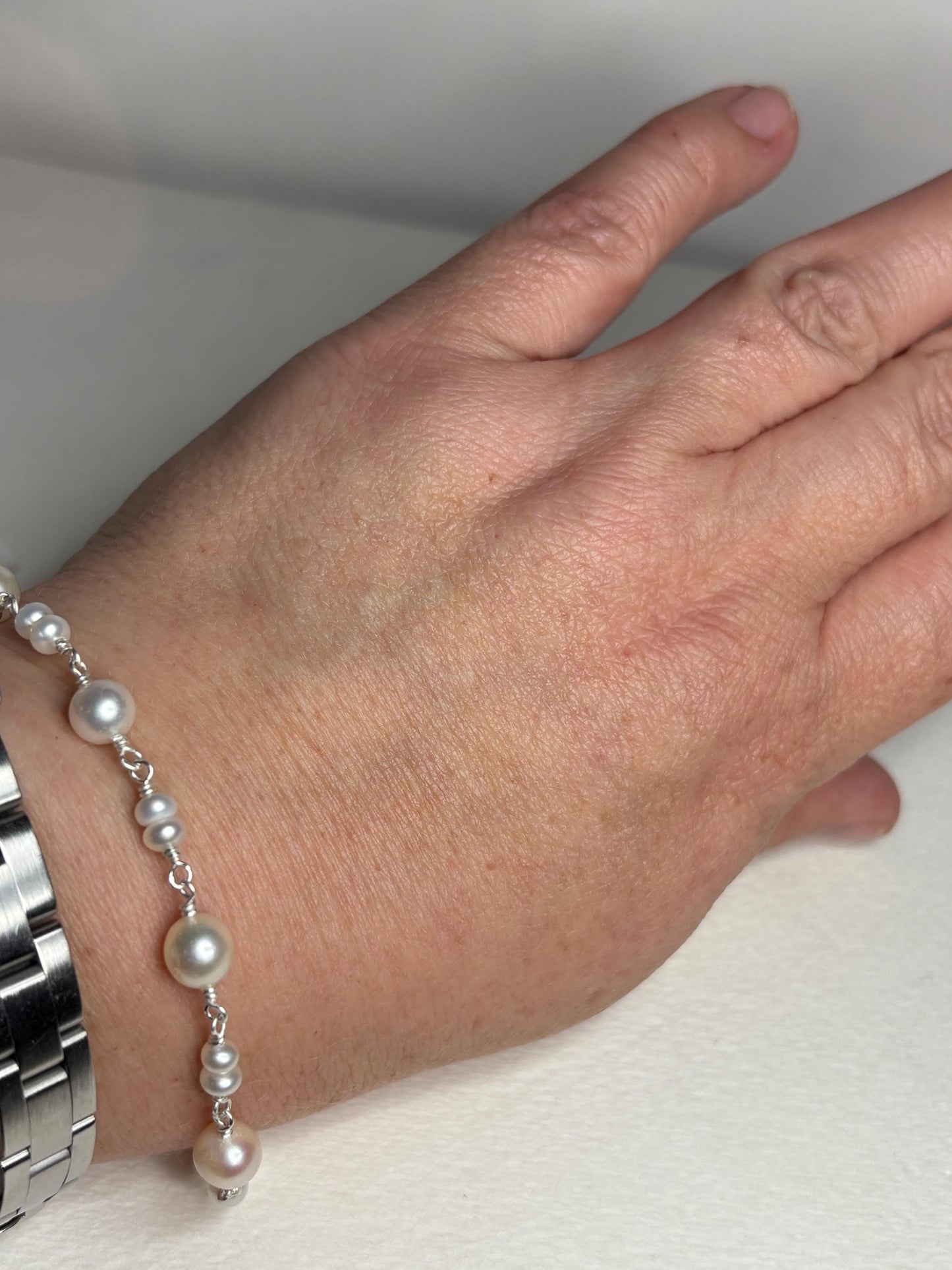 Sterling silver bracelet with cultured freshwater pearls.