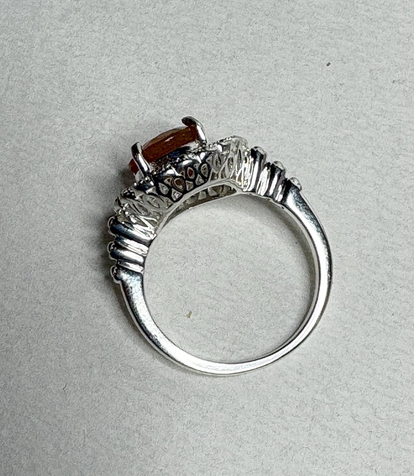 Sterling silver ring with a round Oregon fire opal and lacy filigree setting.