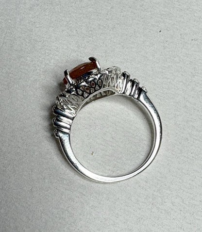 Sterling silver ring with a round Oregon fire opal and lacy filigree setting.