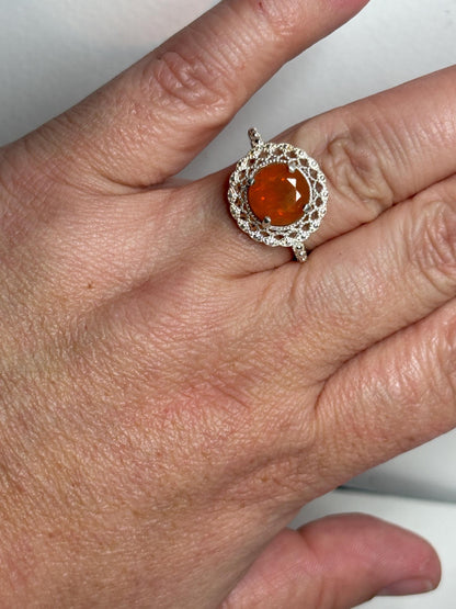 Sterling silver ring with a round Oregon fire opal and lacy filigree setting.