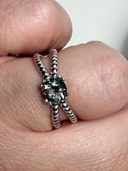Sterling silver ring with a greenish sunstone and rope design.