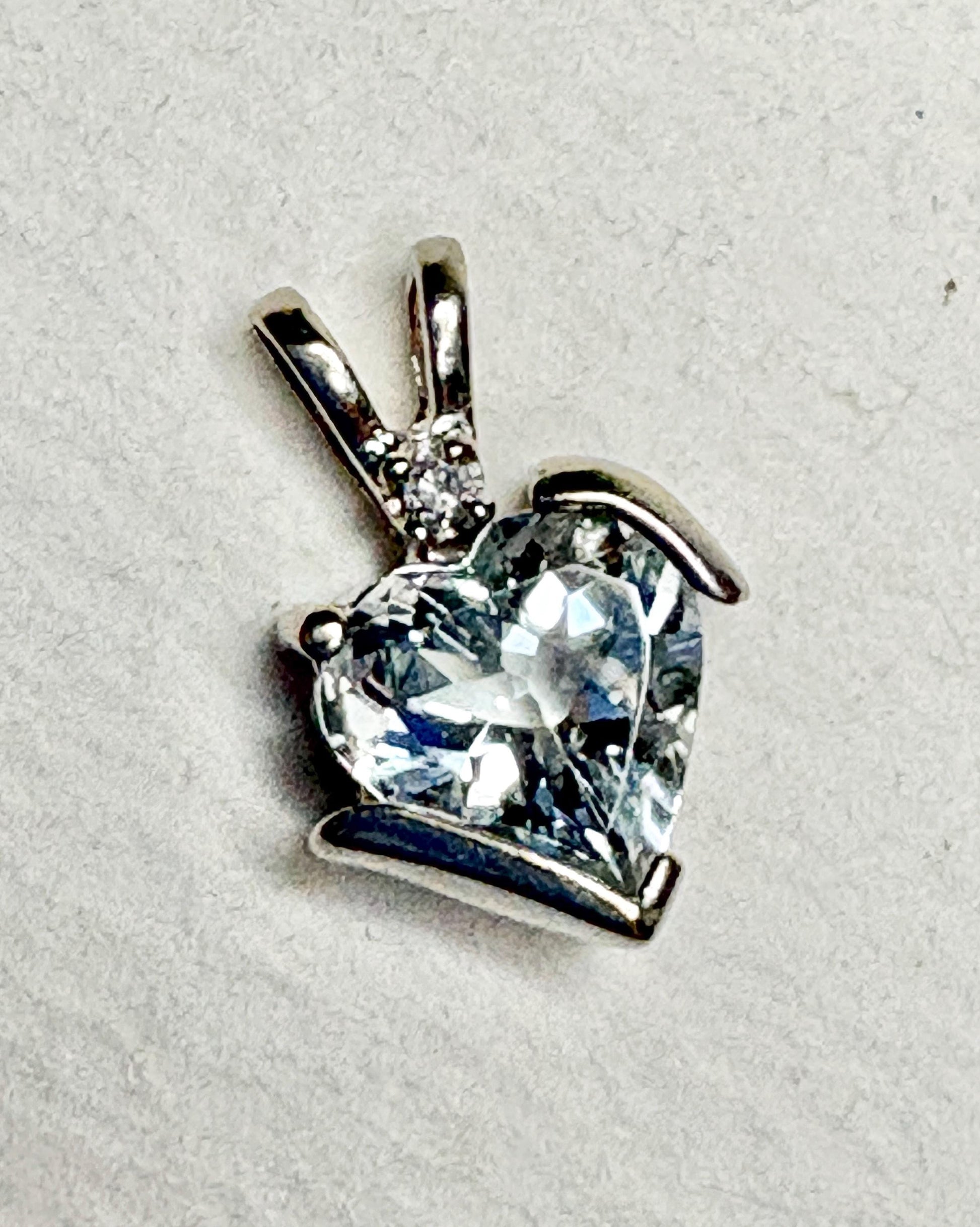 Aquamarine and diamond heart pendant in 10k white gold.