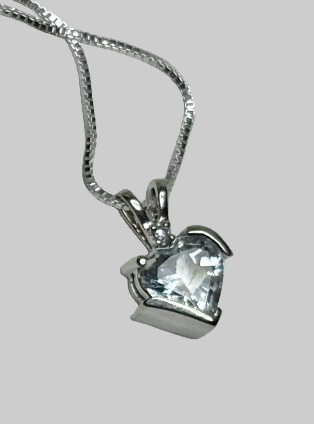 Aquamarine and diamond heart pendant on a silver chain.