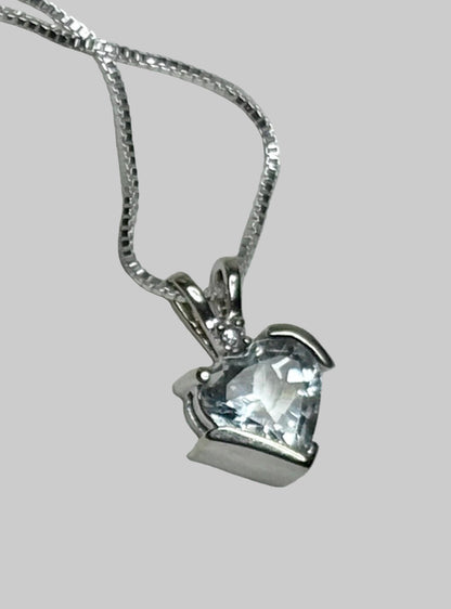 Aquamarine and diamond heart pendant on a silver chain.