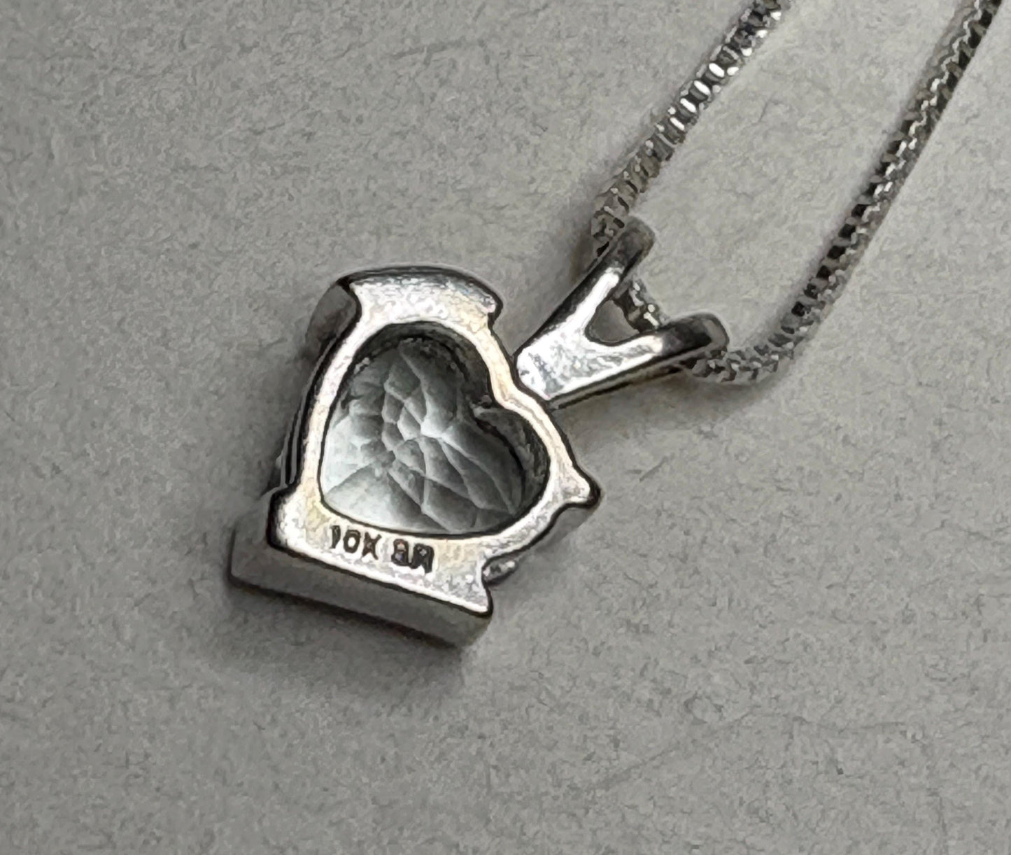 10k gold heart pendant with aquamarine and diamond on a sterling silver chain.