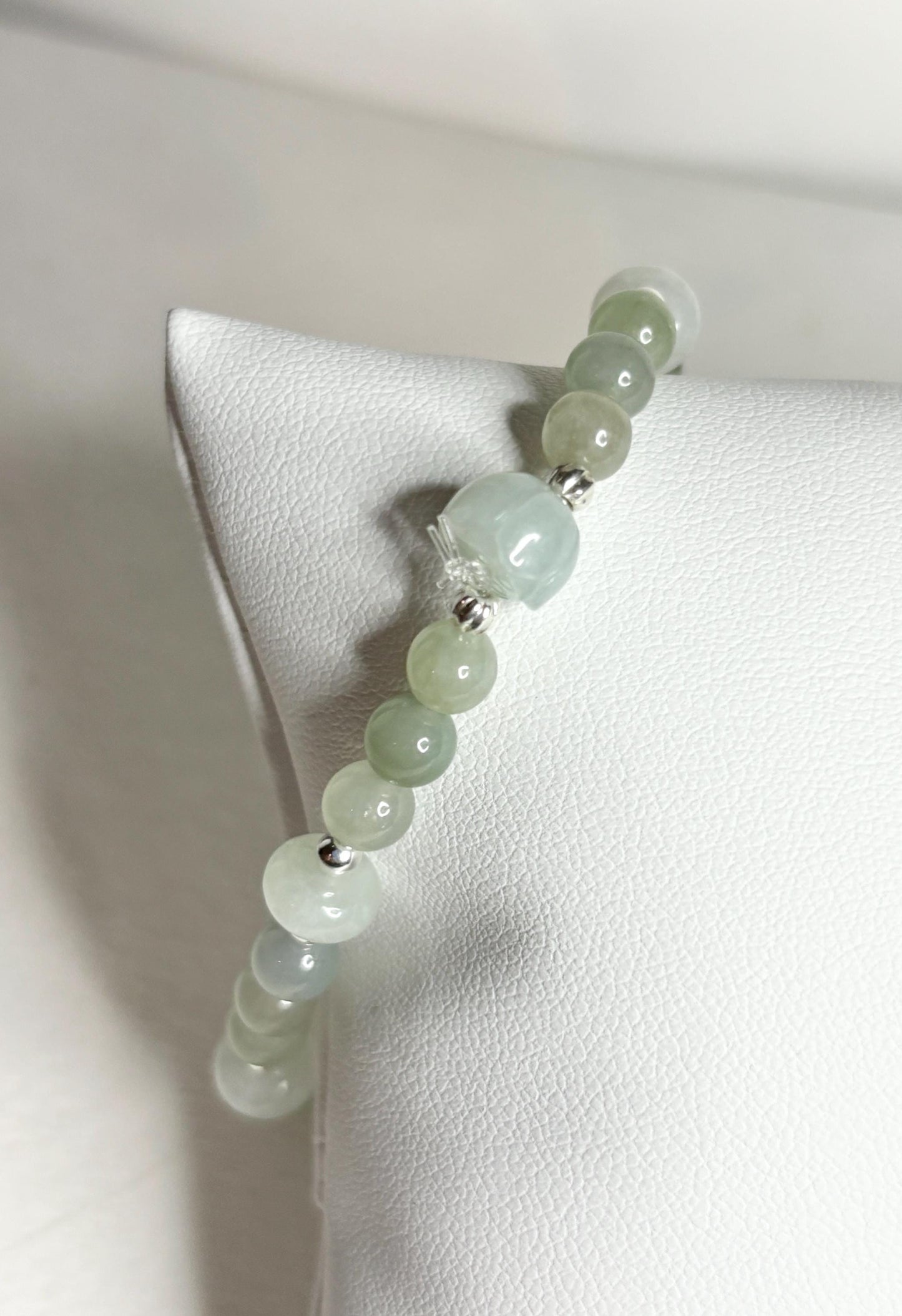 Natural Type A icy Burmese jadeite jade sterling silver stretch bracelet with round and lotus bud beads.