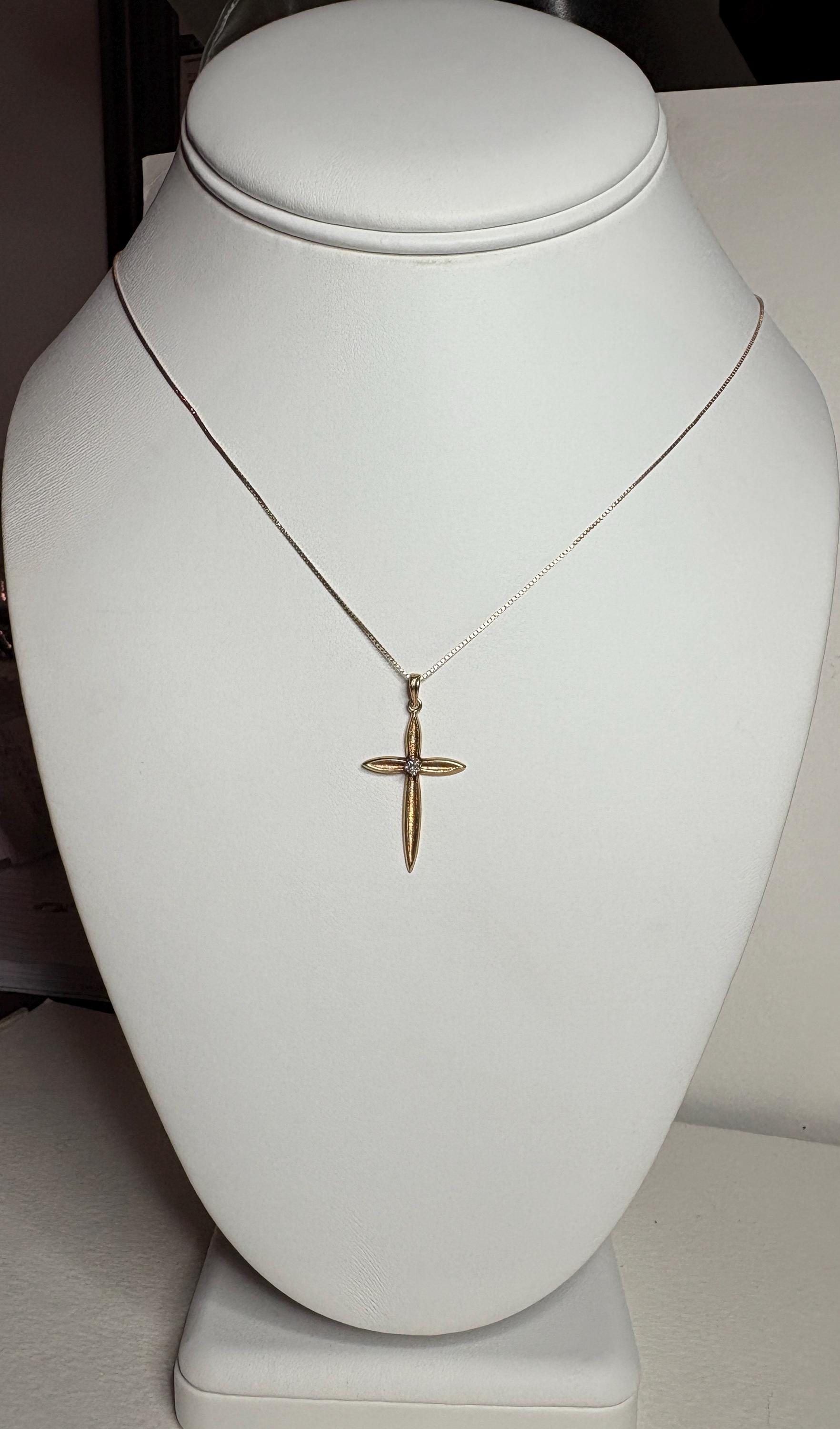 Diamond cross pendant necklace on a 10k gold box chain.