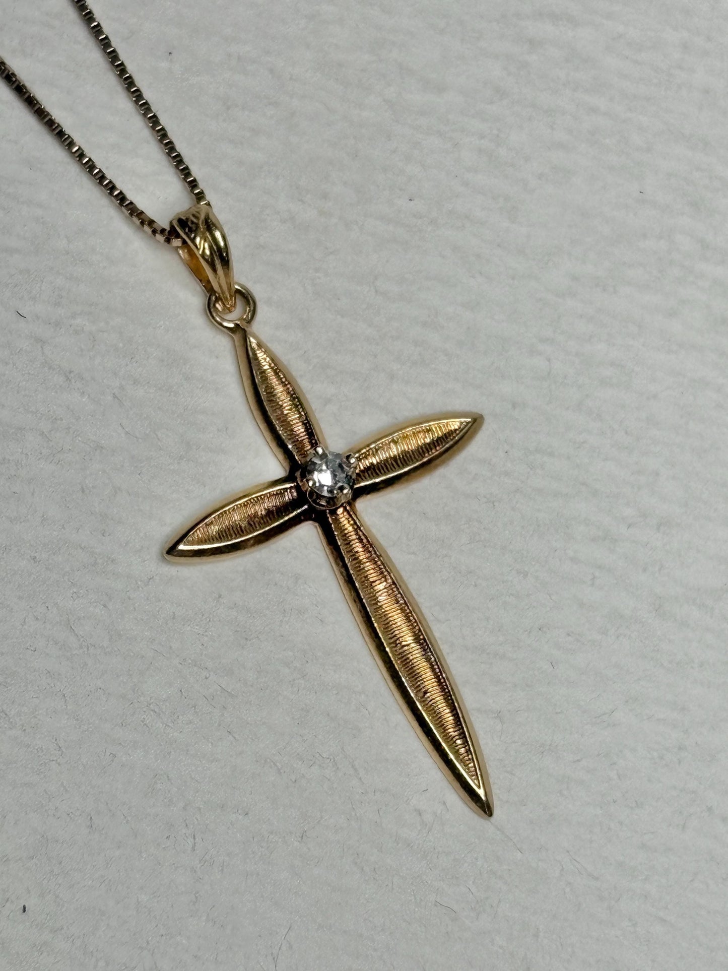 Solid 14k gold cross pendant with a diamond on a 10k gold box chain.