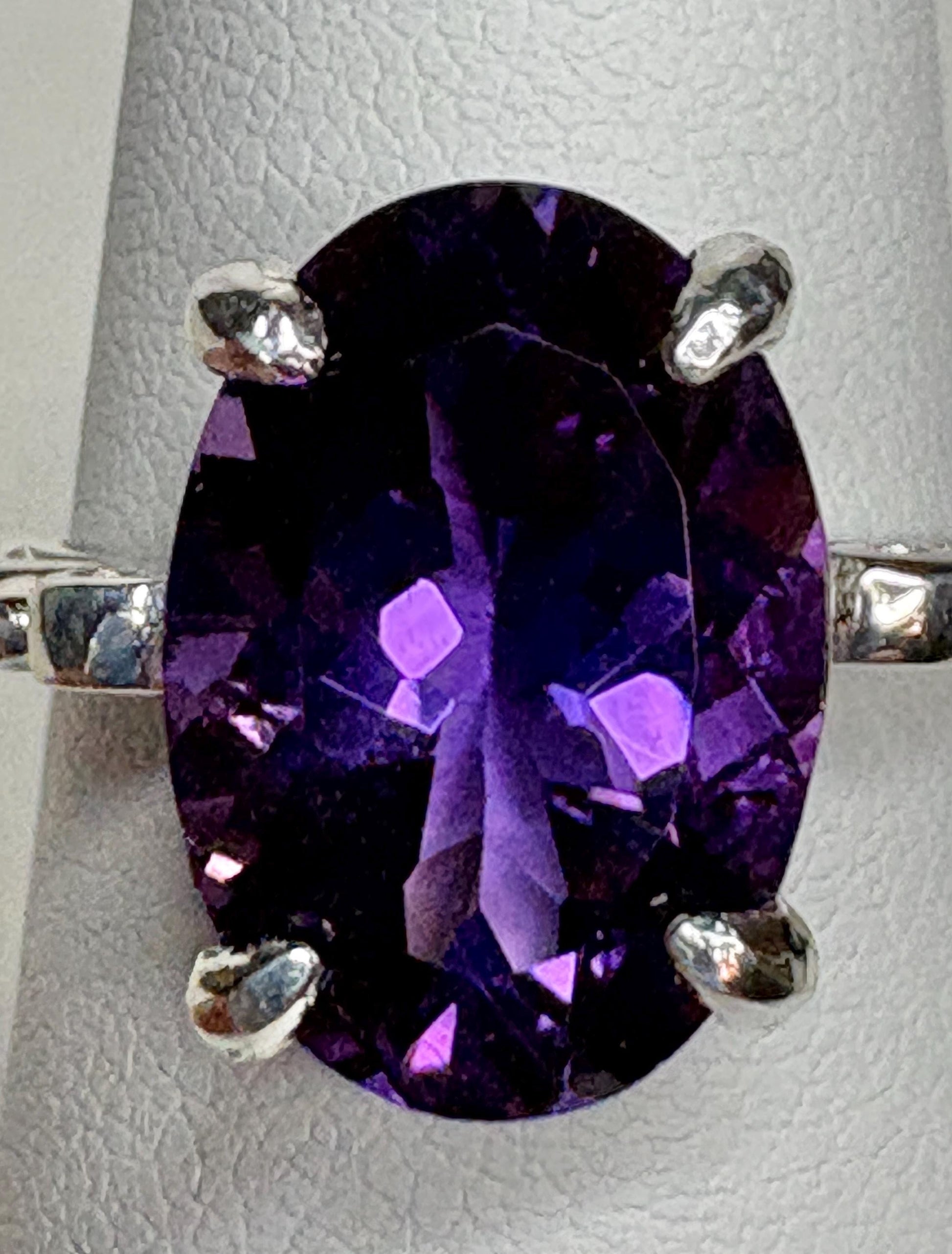 Sterling silver ring with a large oval amethyst gemstone.