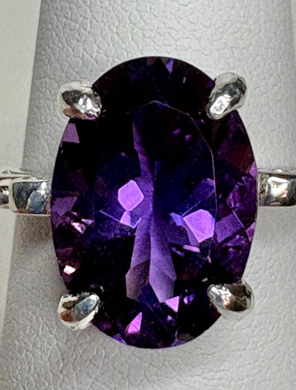 Sterling silver ring with a large oval amethyst gemstone.